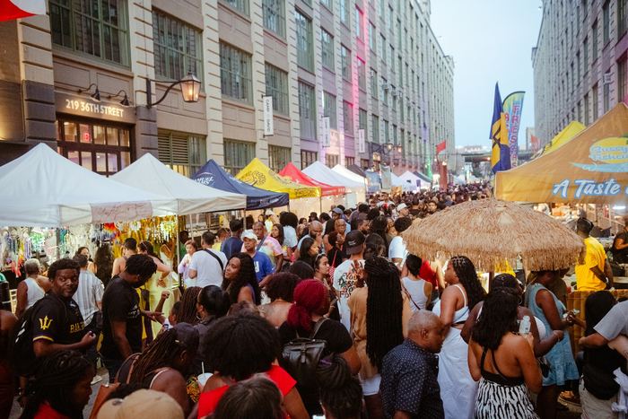 A packed Brooklyn street market, tents and crowd running the length of the block.